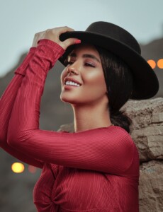 smiling woman wearing red long-sleeved shirt