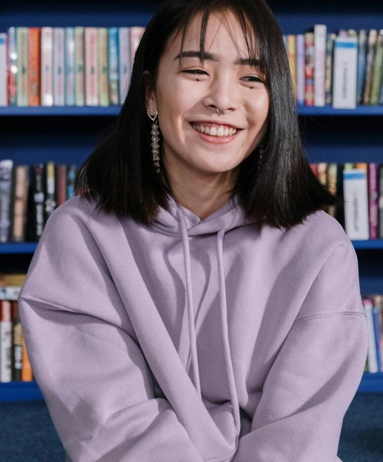 A Young Woman in Purple Hoodie Smiling