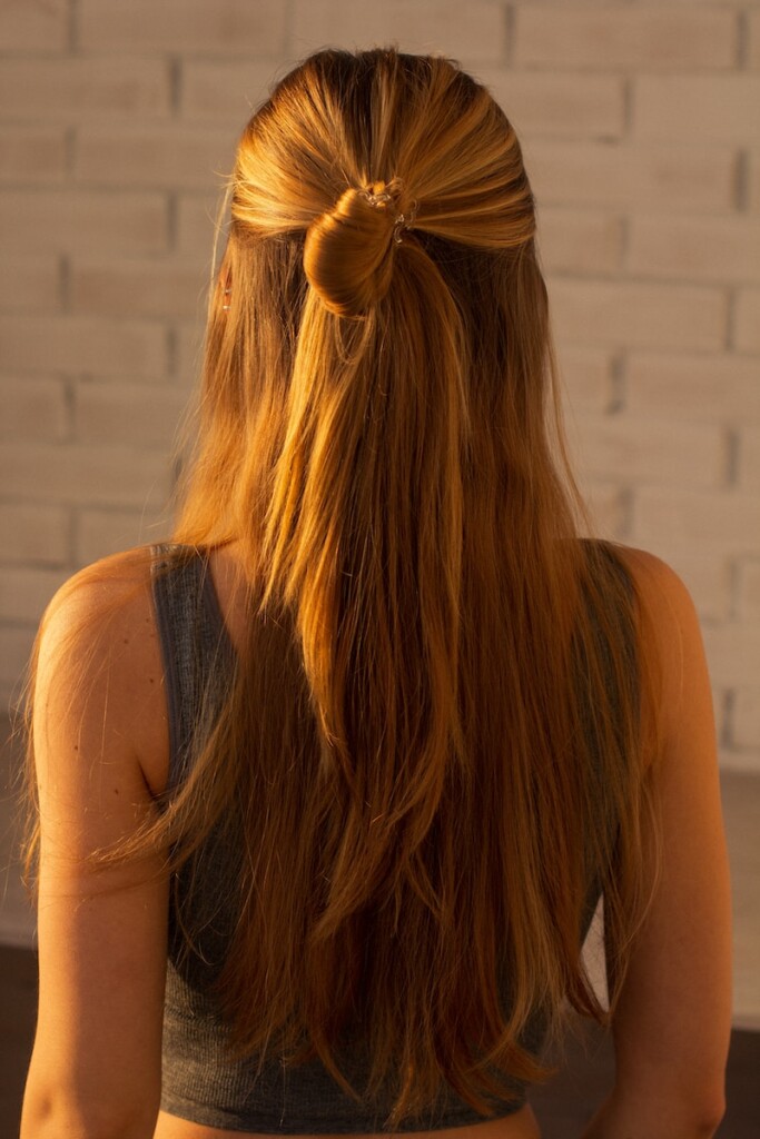 woman in black tank top with brown hair tie