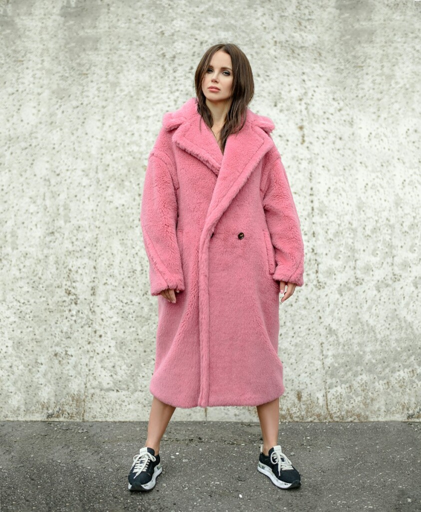 woman standing while wearing pink coat